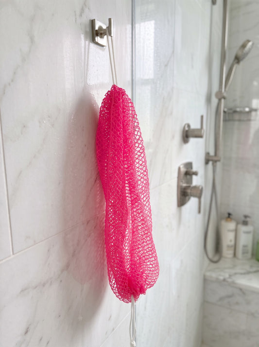 Bright Pink African net sponge hanging in a shower