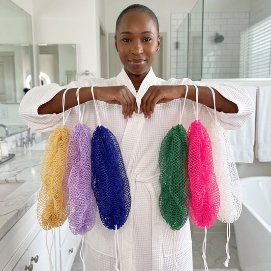 Muduna, founder of House of Imela, holding African net sponges in six colors