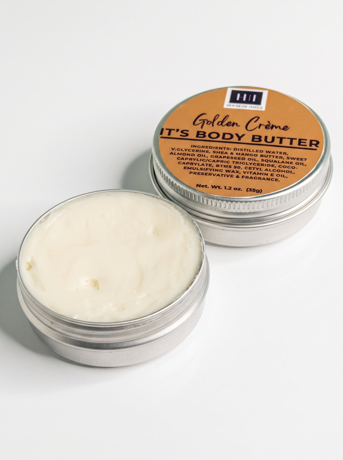 Open Golden Crème Body Butter mini tin showing the butter's texture