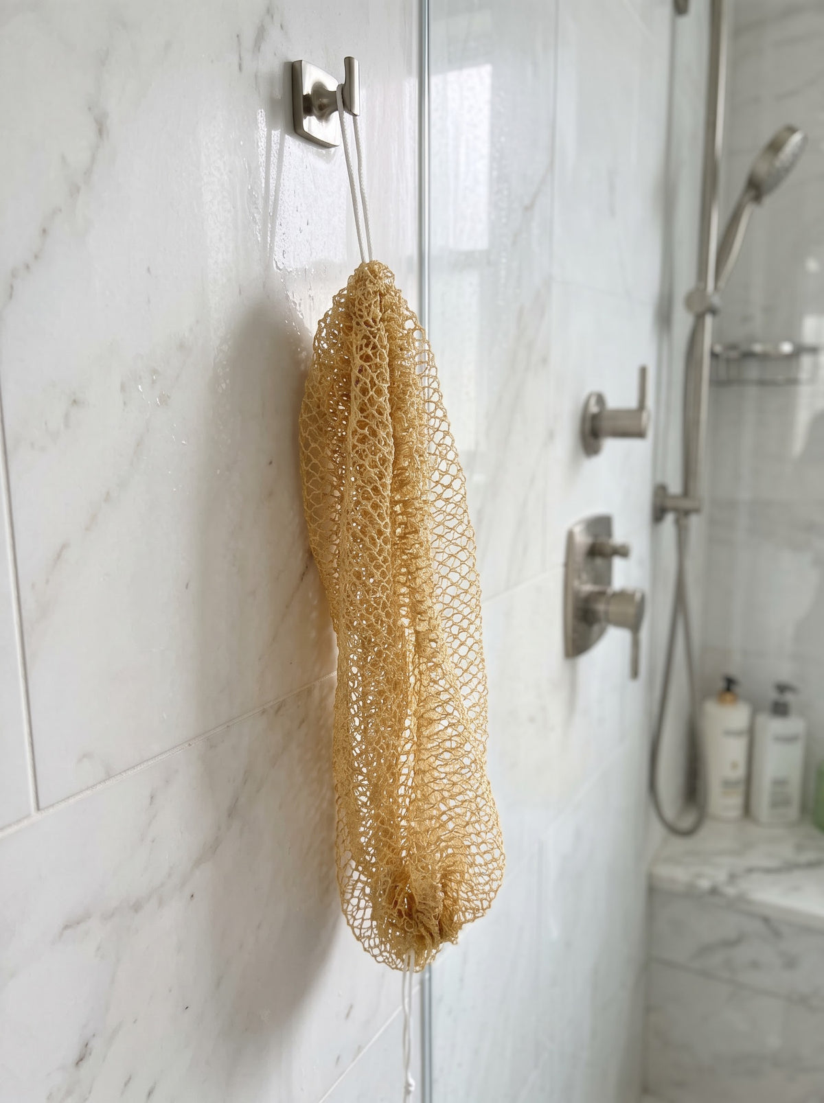 Mustard African net sponge hanging in a shower