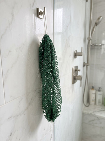 Deep Green African net sponge hanging in a shower
