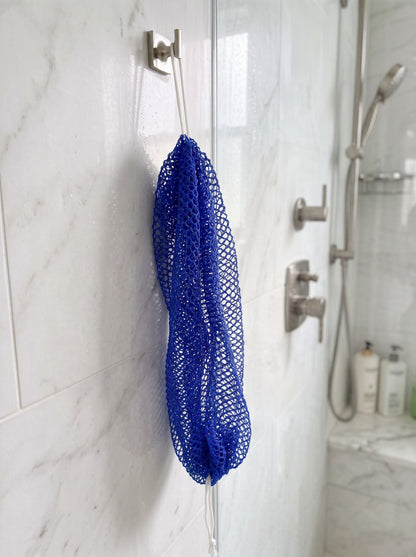 Deep Blue African net sponge hanging in a shower