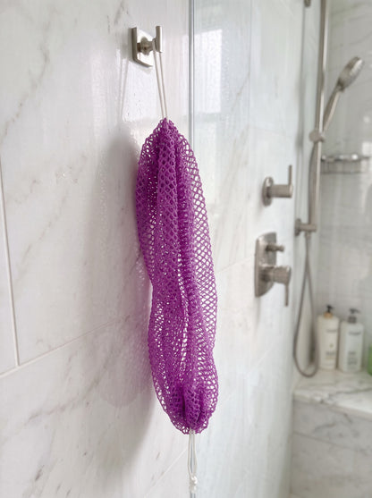Lilac African net sponge hanging in a shower