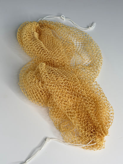 Mustard African net sponge laid flat