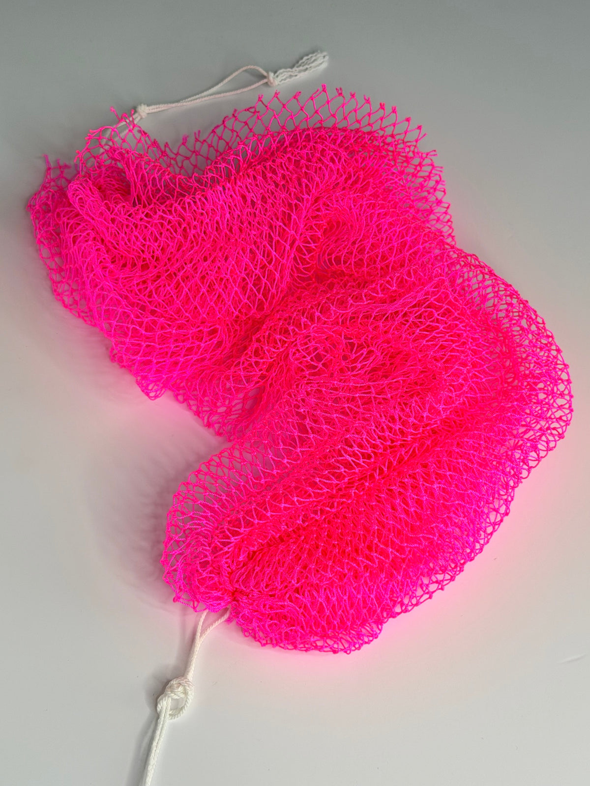 Bright Pink African net sponge laid flat