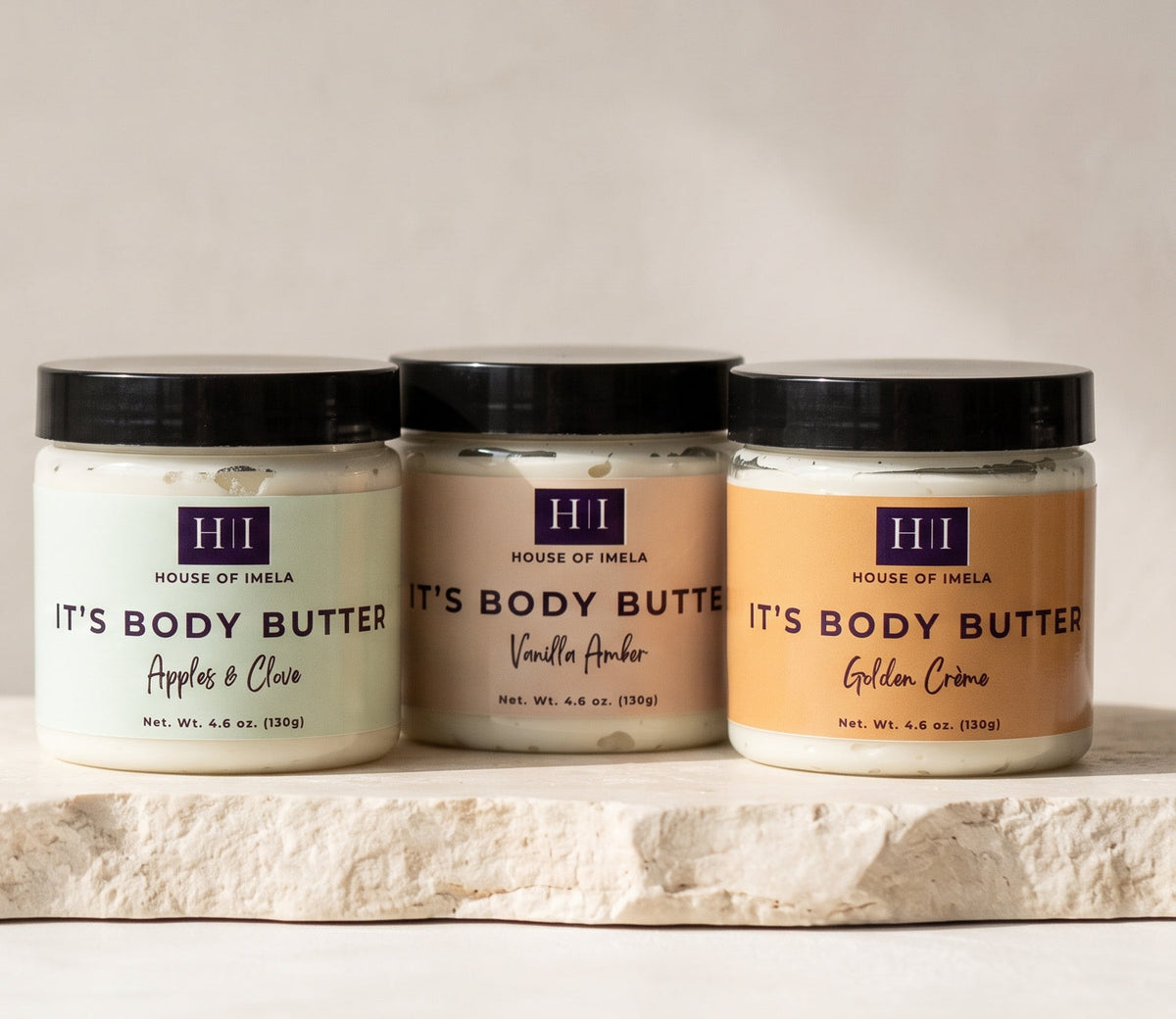 Golden Crème, Vanilla Amber and Apples & Clove body butters on stone